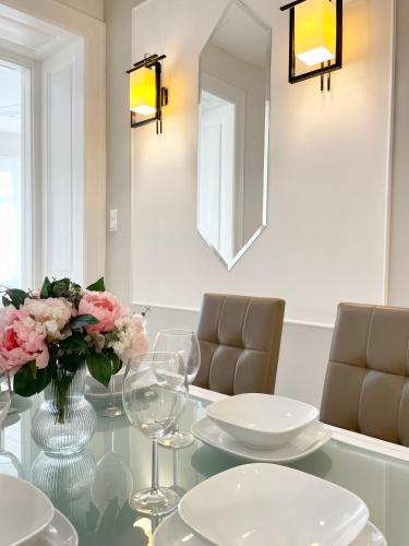 a dining room with a glass table with a vase of flowers at Trigon Palace in Budapest