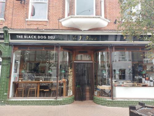 a black dog ball store front with glass windows at Straw Bale Cottage in Halesworth