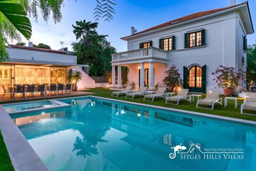a house with a swimming pool in front of it at Villa De Los Leones in heart of Sitges by Beach and Town with A/C and Games in Sitges
