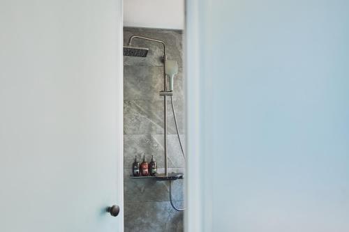 a shower is shown through a door at The Blue by Just Inn in Taipei