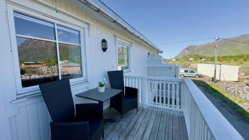 a balcony with a table and chairs on it at Orcas View Vestresand Lofoten in Bøstad