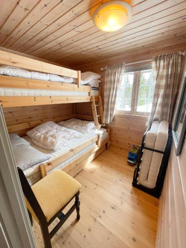 a room with two bunk beds in a cabin at Middagslia - cabin at Skrim with amazing view in Omholt