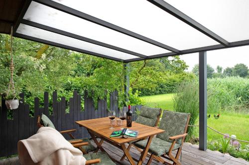 a patio with a wooden table and chairs at Entenhaus in Hilgendorf