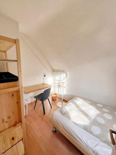a bedroom with a bed and a desk and a ladder at Dein Haus für den Zürich-Trip! in Adliswil