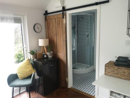 a bathroom with a shower with a glass door at Stylish apartment in Horsham with parking and own entrance in Horsham