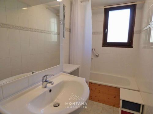 a bathroom with a sink and a tub and a window at Charmant appart. 70m², 2 chambres, mezzanine, balcon sud, garage, près commerces, navettes - FR-1-458-110 in Le Grand-Bornand