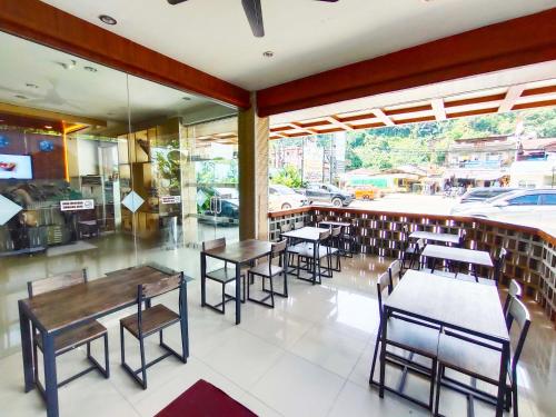 a restaurant with tables and chairs in a room at Royal Park Hotel in Samarinda