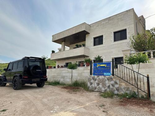 a jeep parked in front of a building at Jerash City View in Jerash