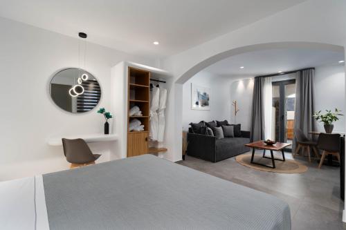 a bedroom with a bed and a living room at LyMaRou Collection in Megalokhori