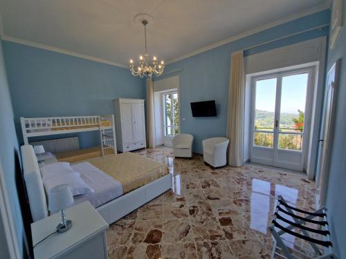 a bedroom with a bed and a large window at VILLA ESMERALDA in Salerno