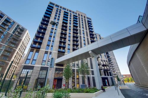 a tall building with tall buildings in a city at The Robinson at Wembley - Modern and Eclectic in London