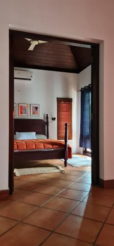 a bedroom with a large bed in a room at The Frangipani Marari Beach in Mararikulam