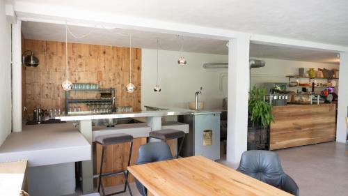 a kitchen with wooden walls and a table and chairs at Pension Hanslmann in Steinbach am Attersee