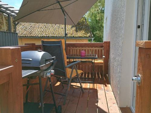 an umbrella sitting on a patio with a grill at Ferienwohnung zur Wacht in Viechtach
