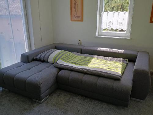 a couch with a blanket on top of it in a room at Ferienwohnung zur Wacht in Viechtach