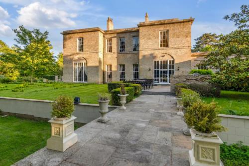 an exterior view of a mansion with a courtyard at Must see - Georgian Mansion I Suffolk Retreat in Beccles
