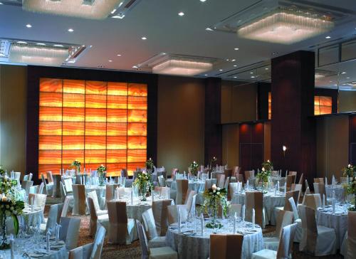 a banquet hall with white tables and white chairs at JEN Penang Georgetown by Shangri-La in George Town