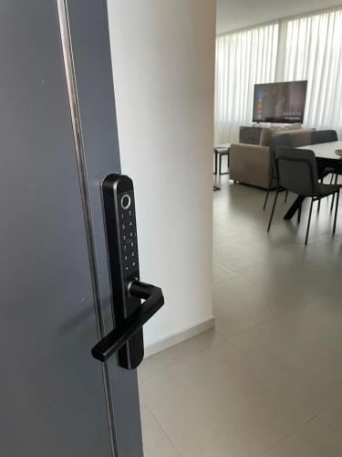 a door handle in a room with a living room at Villa 7 SanPietro in Durrës