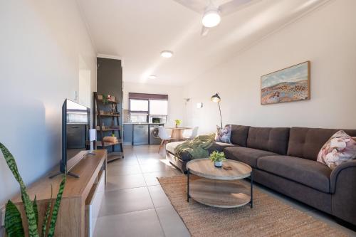 a living room with a couch and a table at Ballito Village Luxury Apartments in Ballito