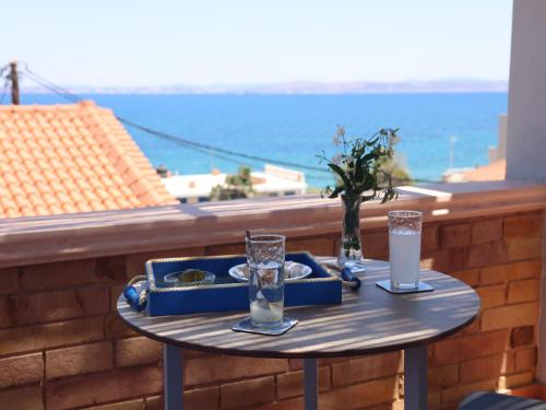 a table with two glasses of water on a balcony at Chios Shallow Sea in Karfas