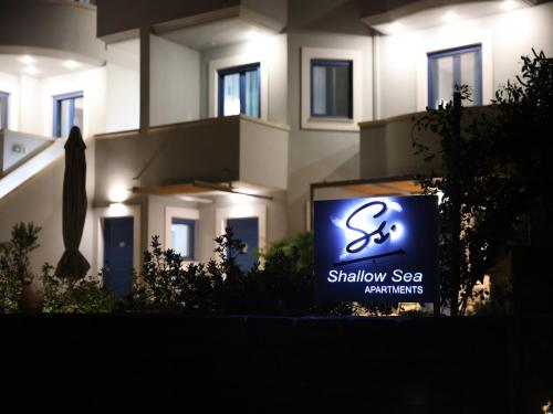 a sign in front of a building with a sign for a showroom with at Chios Shallow Sea in Karfas