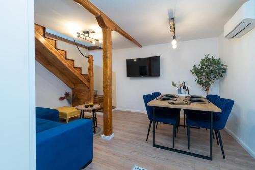 a living room with a table and a blue couch at Duplex apartment Domi in Slatine