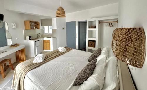 a bedroom with a large bed and a kitchen at San Salvatore in Zakynthos Town