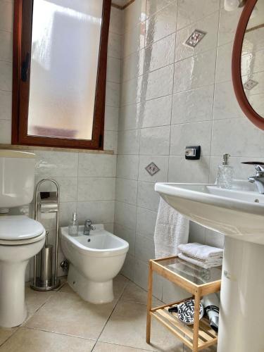 a bathroom with a toilet and a sink at La Casa di Pippo in Augusta