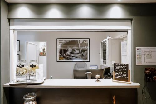 una encimera con espejo en una habitación en Idéal Séjour - Boutique Hôtel Cosy, en Cannes
