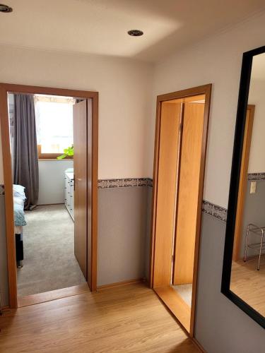 a room with two open doors and a mirror at 75qm Apartment in Burgstaedt