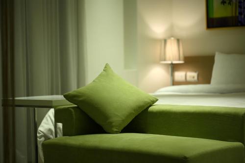 Una cama o camas en una habitación de Hsiangkelira Hotel