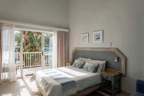 Posteľ alebo postele v izbe v ubytovaní Beach Cabanas