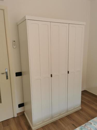 a white closet with white cabinets in a room at VERDEACQUA Flat in Rapallo