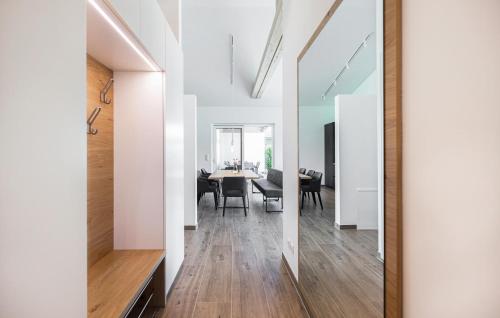 a hallway with white walls and a dining room with a table at Villa Mit Pool In Stegersbach in Neudauberg