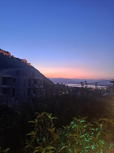 a view of a city with a sunset in the background at Hotel Vasilis Nafplio in Nafplio