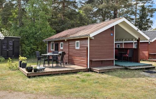 a small cabin with a table on a deck at Beautiful Home In Nexø With Kitchen in Neksø