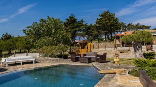 a pool in a yard with chairs and a playground at Kochab Sintra by LovelyStay in Sintra