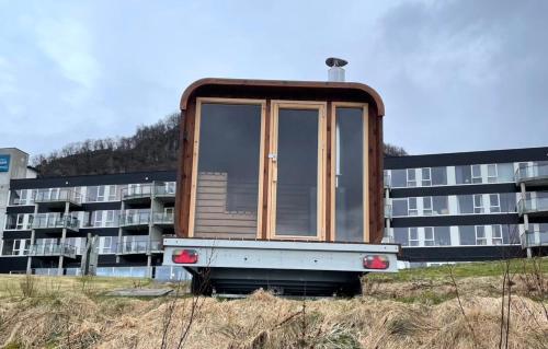 a house sitting on the back of a building at Smaken av Ryfylke Event AS overnatting, Bygningen drives ikke som hotell in Hjelmeland