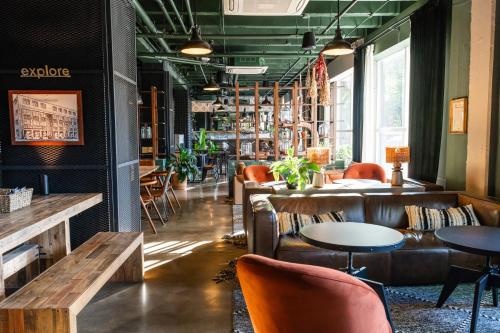 a restaurant with leather chairs and tables and a bar at Hotel Nell - Union Market in Washington