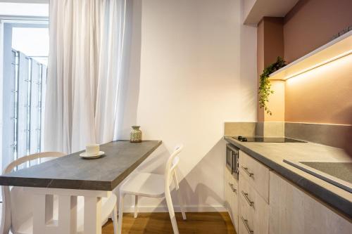 a kitchen with a table and a counter top at The Dorians in Athens