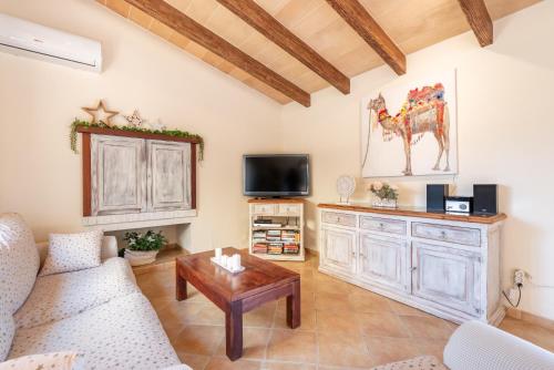 a living room with a couch and a table at Can Xuri in Campos