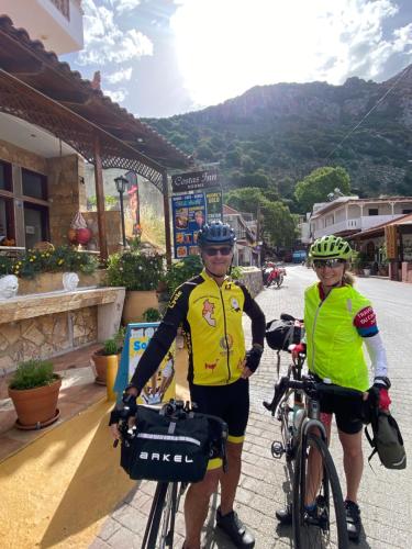 two people standing with their bikes on a street at Costas Inn in Spílion