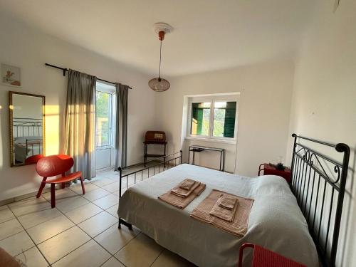 a bedroom with a bed and a chair and a window at Casa vacanze da Tonino in Noci