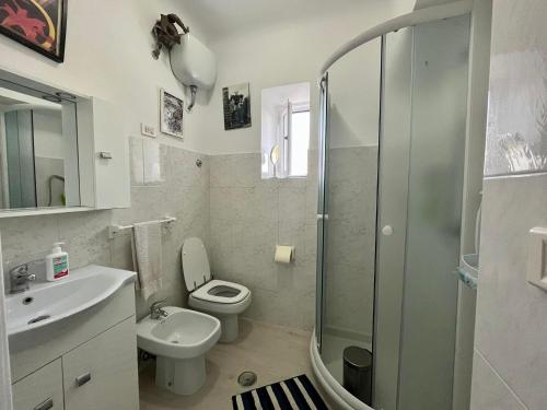 a bathroom with a toilet and a sink and a shower at Casa vacanze da Tonino in Noci