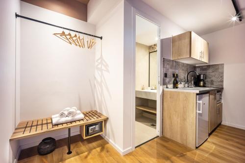 a small kitchen with a table in a room at The Dorians in Athens