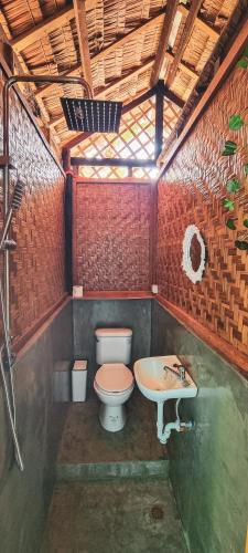 a bathroom with a toilet and a sink at Blue House Backpackers Siquijor in San Juan