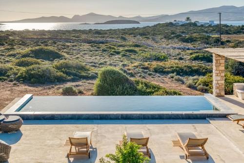 a villa with a pool and a view of the desert at Villa Sand and Stone in Aliki
