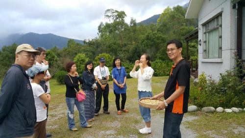 a group of people standing outside of a house at Taroko Sialin Coffee Farm Homestay in Xiulin