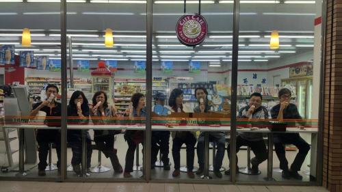 a group of people taking selfies in a store mirror at Taroko Sialin Coffee Farm Homestay in Xiulin