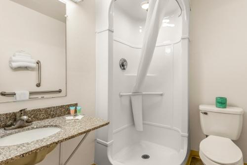 a bathroom with a shower and a toilet and a sink at Americas Best Value Inn - Lake City in Lake City